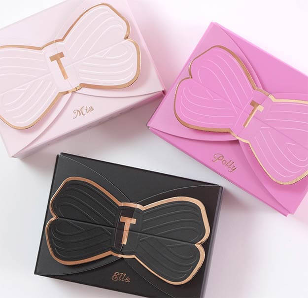 Ted Baker fine fragrance gift packaging. Boxes with bow detailing, black, pink and white with gold foil. Mia, Polly, Ella