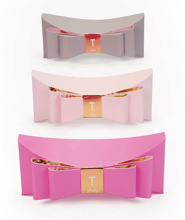 Ted Baker fine fragrance gift packaging. Boxes with bow detailing, black, pink and white with gold foil. Mia, Polly, Ella