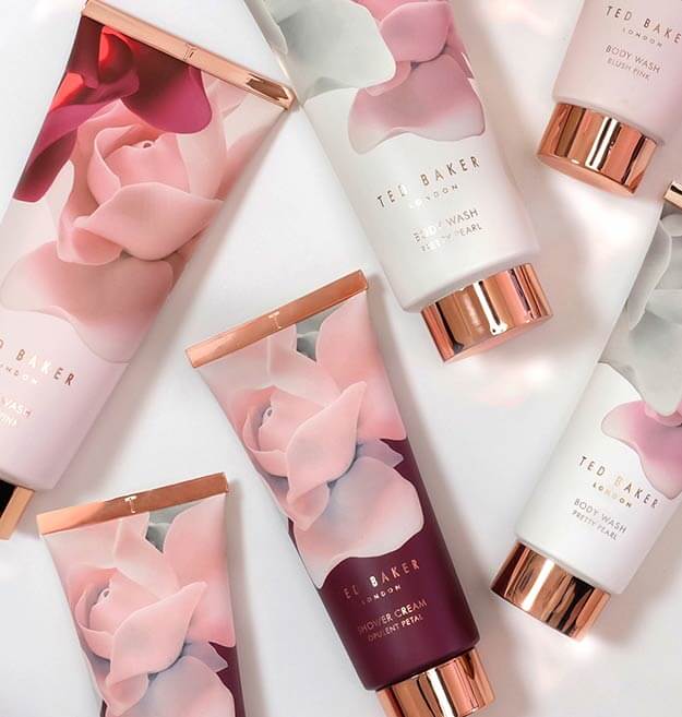 Ted Baker indulgent bathing products in tubes with floral pattern and rose gold metallic detailing.