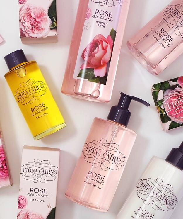 Fiona Cairns Rose Gourmand indulgent bathing bath products on white background. Floral photography. Waitrose.